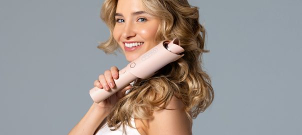 a woman holding a hair dryer in her hand