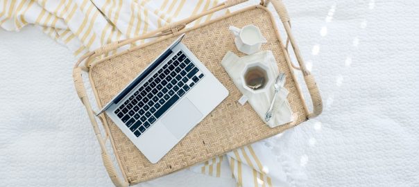 gray laptop computer on beige wicker chair