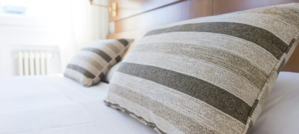 gray and black throw pillow on bed