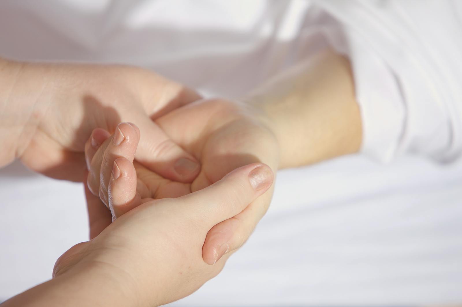 Relaxing hand massage therapy session close-up with gentle touch and care.