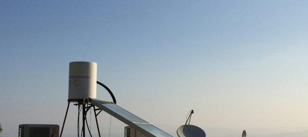 white satellite dish on gray concrete floor during daytime