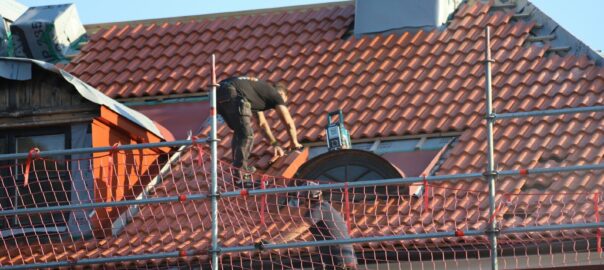 A man on a roof working on a roof
