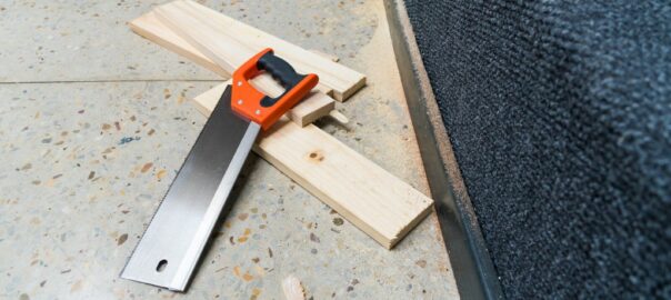 a pair of scissors and a piece of wood on the ground